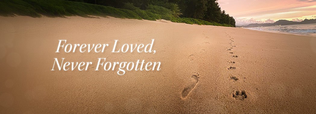 Human footprints and pawprints in the sand with the text 'Forever Loved, Never Forgotten'